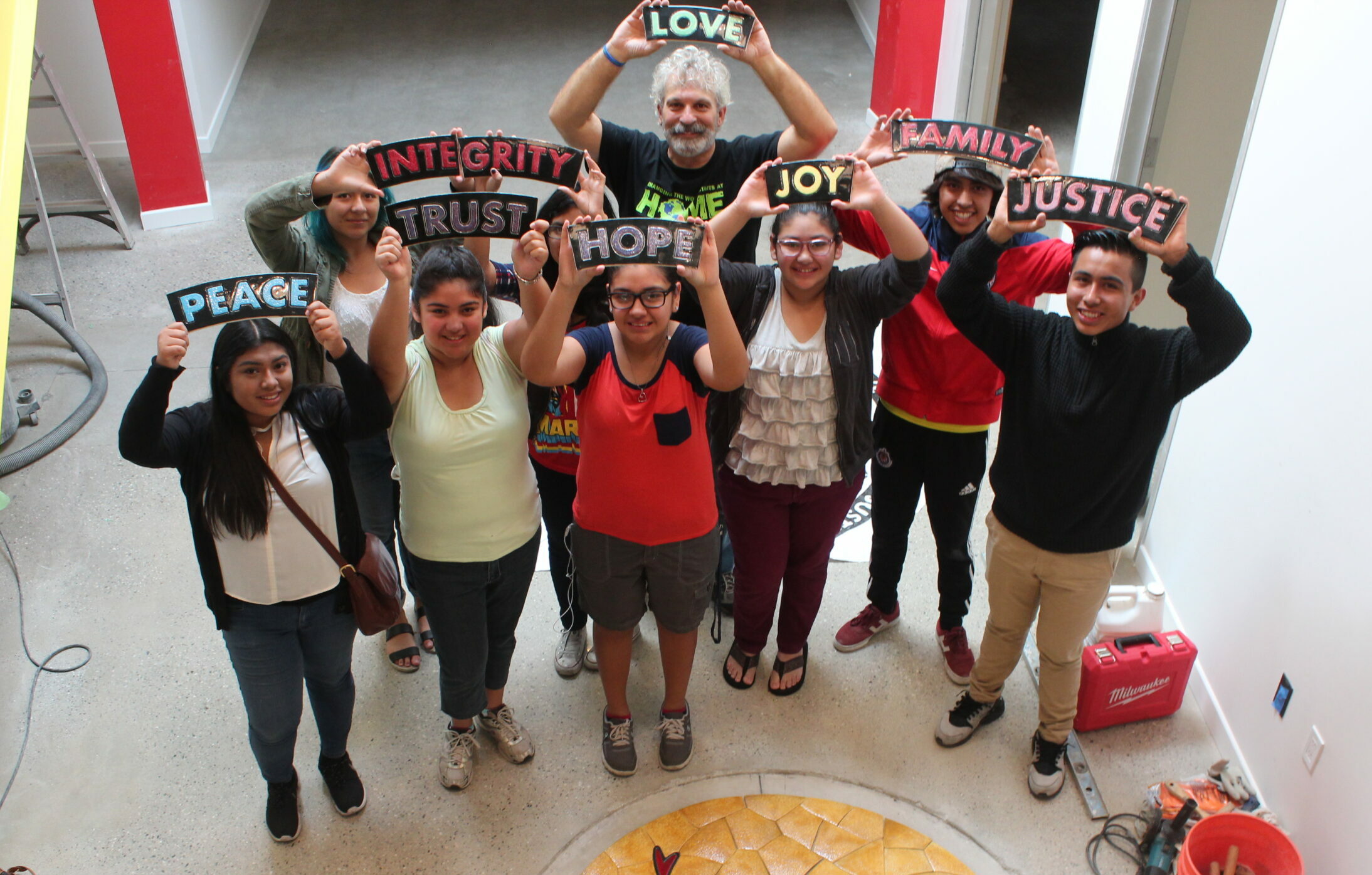 Group photo with core value signs being held up